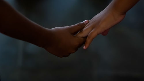 Cropped image of couple holding hands