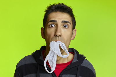 Portrait of young man against gray background