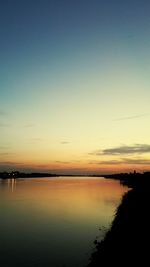 Scenic view of lake against romantic sky at sunset