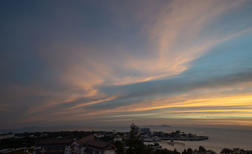 High angle view of illuminated buildings against sky at sunset