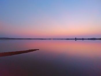 Scenic view of lake against sky at sunset