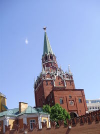 Low angle view of clock tower against blue sky