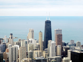 High angle shot of cityscape against calm sea