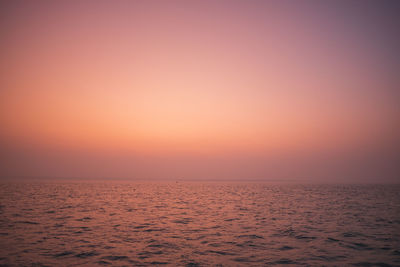 Scenic view of sea against orange sky