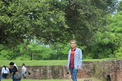 Full length of friends standing in park