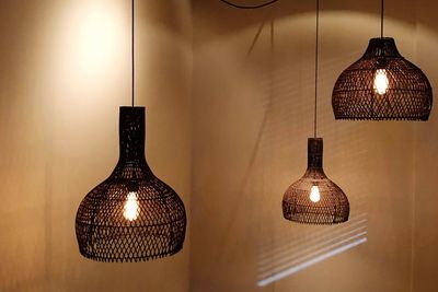 Close-up of illuminated lamp on table at home