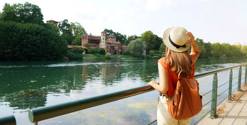 Young woman relaxing on po promenade river in turin, italy