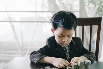 Portrait of boy looking at table