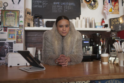 Young woman at store counter.