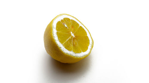 Close-up of lemon slice over white background