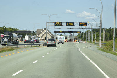 Vehicles on road against sky