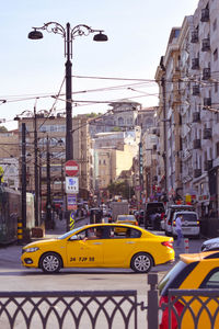 Traffic on road against buildings in city