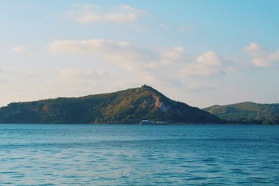 Scenic view of sea and mountains against sky