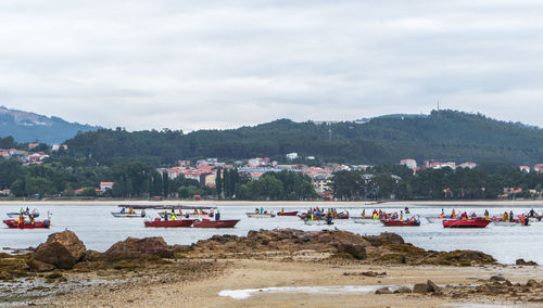 Group of people on beach against sky