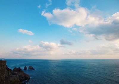 Scenic view of sea against cloudy sky