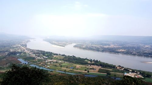 High angle view of river by cityscape against sky