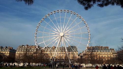 Ferris wheel in city against sky