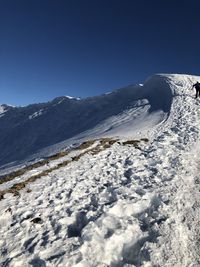 Scenic view of snowcapped mountains against clear blue sky