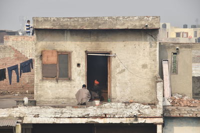 Rear view of man standing against building