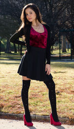 Portrait of beautiful woman standing against tree
