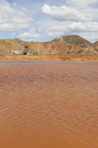 Scenic view of arid landscape against sky