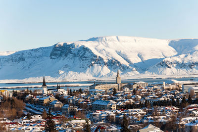 Aerial view of snowcapped mountains against clear sky