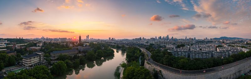 Panoramic view of city buildings during sunset