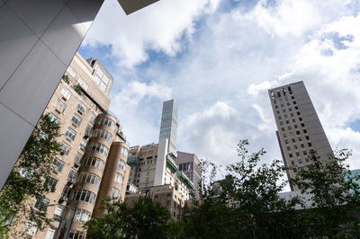 Low angle view of buildings against cloudy sky