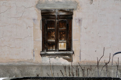 Low angle view of window on old building