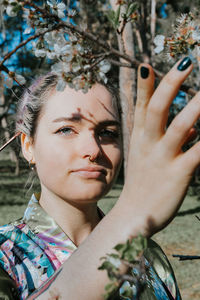 Portrait of woman holding plant