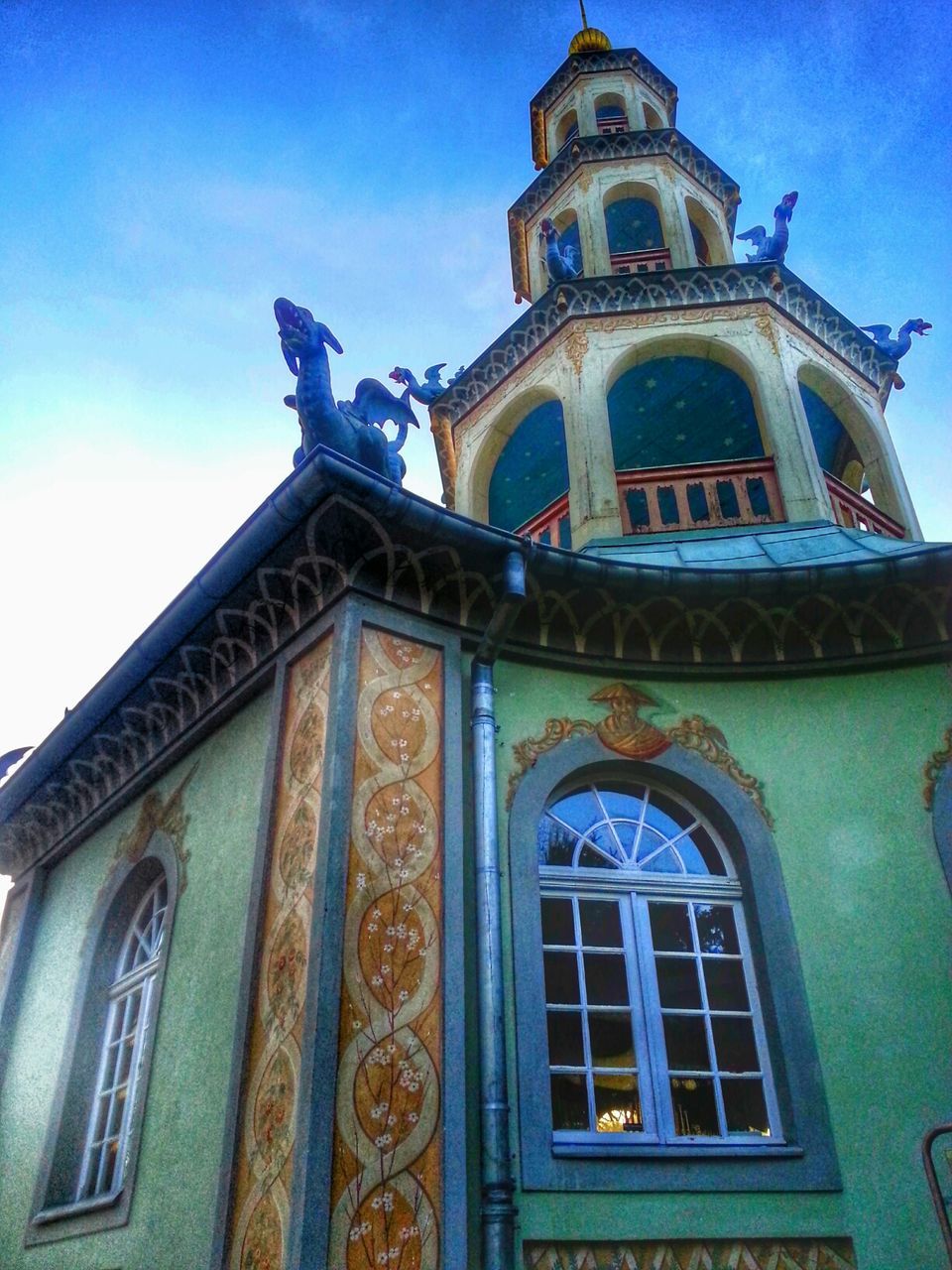 low angle view, building exterior, architecture, built structure, religion, church, place of worship, spirituality, window, blue, sky, facade, cathedral, arch, day, outdoors, no people, clock tower