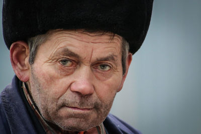 Close-up portrait of man wearing hat