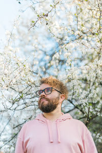 Low angle view of man standing against trees