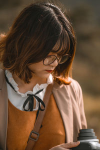 Close-up of woman using camera