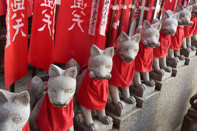 Statue of buddha against red wall