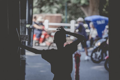 Silhouette boy standing in city