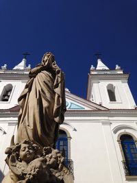 Low angle view of statue against clear blue sky