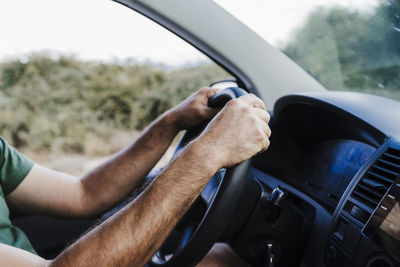 Man driving van on road trip