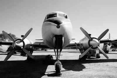 Airplane on runway against sky