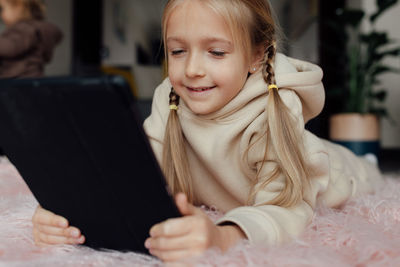 Portrait of young woman using digital tablet