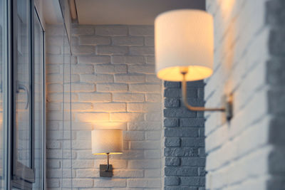 Wall lamp in modern loft apartment. wall sconce on white brick wall. yellow lights in shade