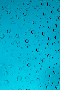 Full frame shot of wet glass window