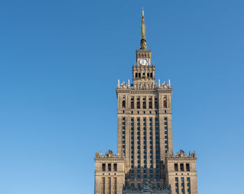 Low angle view of building against clear blue sky