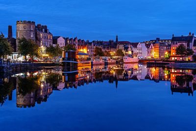 Reflection of illuminated buildings in lake at night