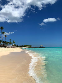 Scenic view of beach against blue sky