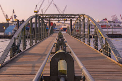 Footbridge over river against sky