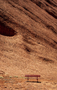 High angle view of empty bench on landscape