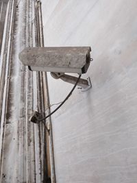 Low angle view of cctv camera on wall