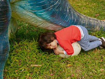 High angle view of girl lying on field