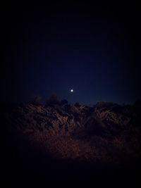 Scenic view of moon against clear sky at night